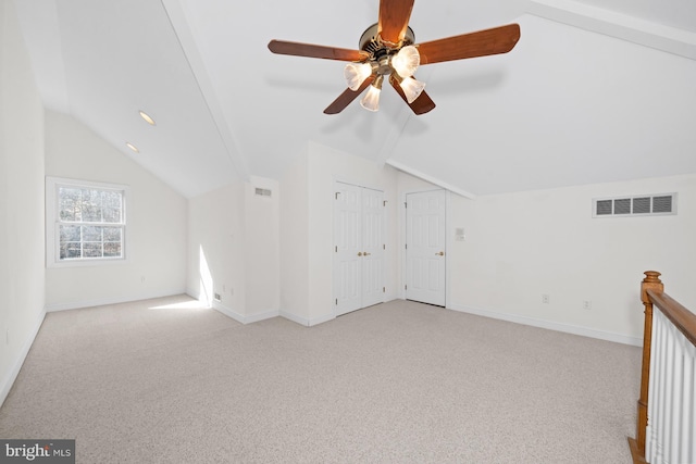 bonus room with vaulted ceiling and light colored carpet