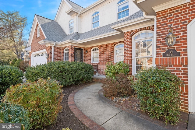 doorway to property with a garage