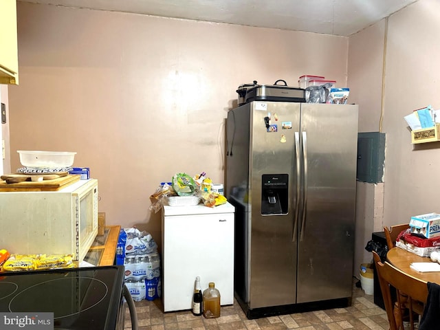 kitchen with white microwave, range with electric cooktop, fridge, and stainless steel fridge with ice dispenser