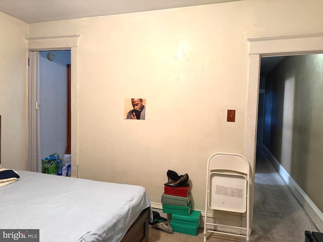 carpeted bedroom featuring baseboards