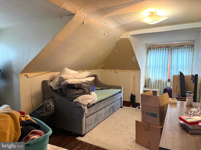 bedroom featuring vaulted ceiling and wood finished floors