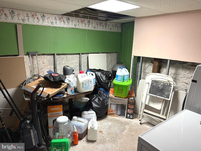 interior space featuring washer / clothes dryer and a drop ceiling