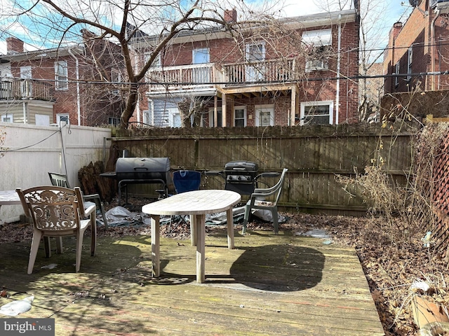 view of patio / terrace with fence, grilling area, and a wooden deck