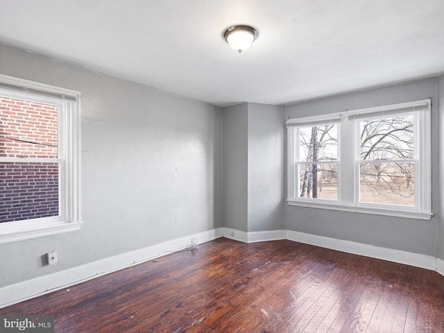 empty room with dark hardwood / wood-style floors