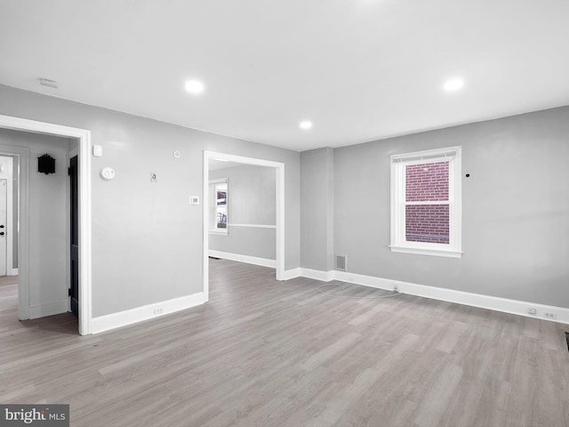 spare room with light hardwood / wood-style floors