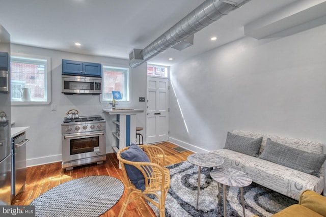 living room featuring a wealth of natural light and dark hardwood / wood-style flooring