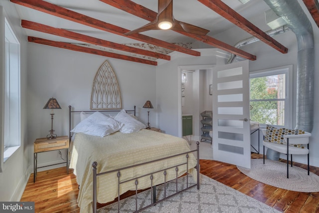 bedroom featuring beam ceiling and wood-type flooring