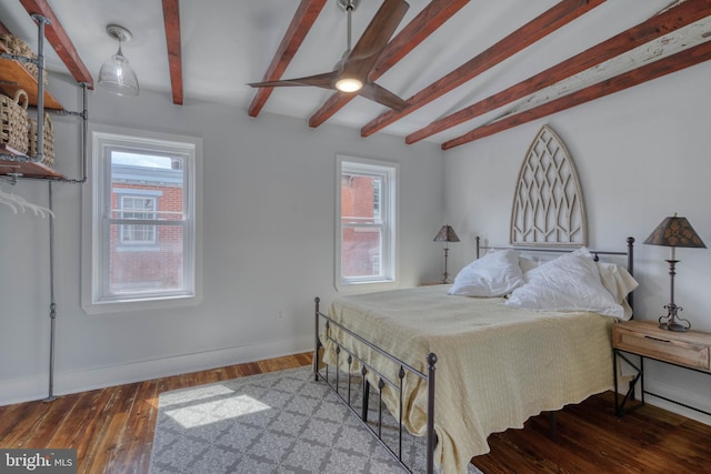 bedroom featuring hardwood / wood-style flooring and beam ceiling