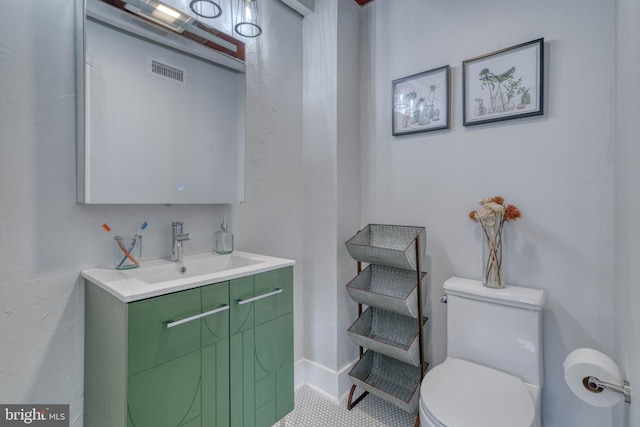 bathroom featuring toilet and vanity