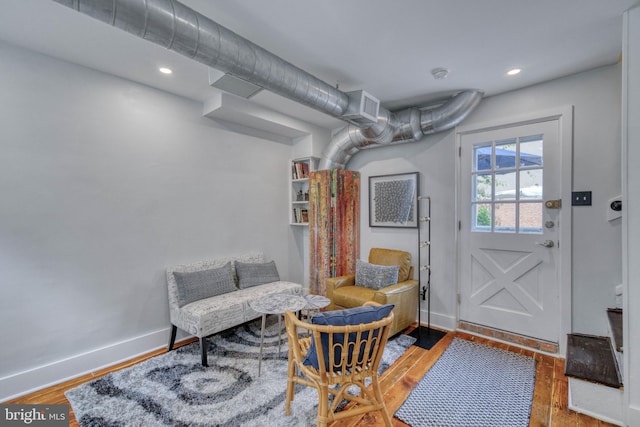 sitting room with wood-type flooring