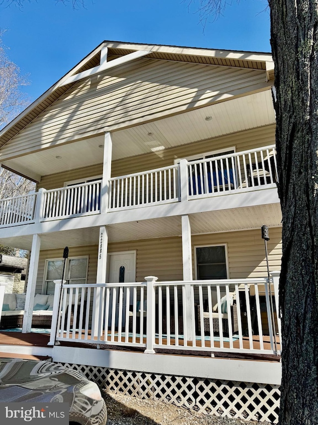 exterior space with covered porch and a balcony