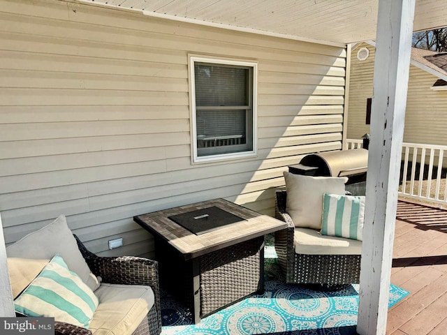 wooden deck featuring an outdoor hangout area