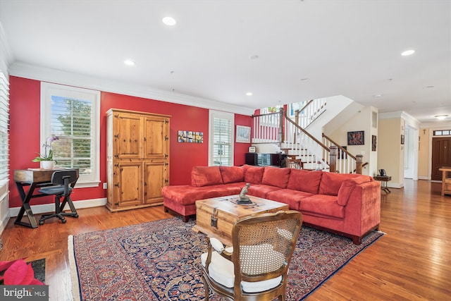 living area featuring light wood finished floors, crown molding, baseboards, stairs, and recessed lighting