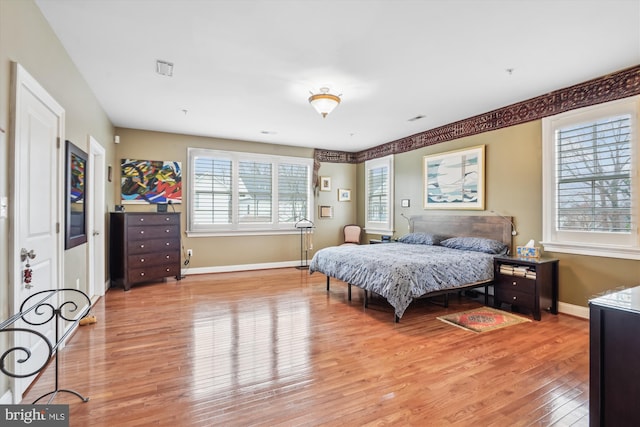 bedroom featuring light wood-style flooring and baseboards