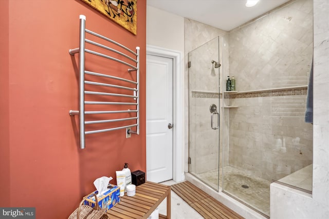 bathroom featuring a shower stall and radiator heating unit