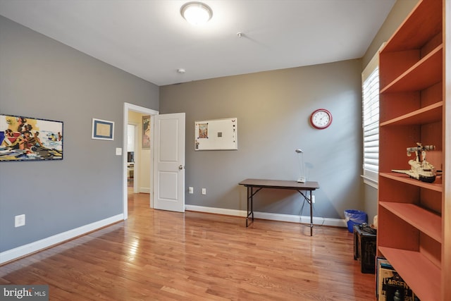 interior space with baseboards and light wood-style floors