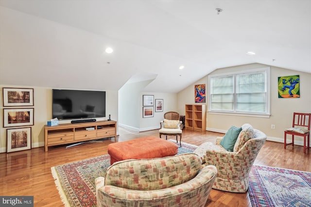 living area featuring vaulted ceiling, recessed lighting, wood finished floors, and baseboards