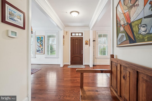 entryway with baseboards, wood finished floors, and ornamental molding