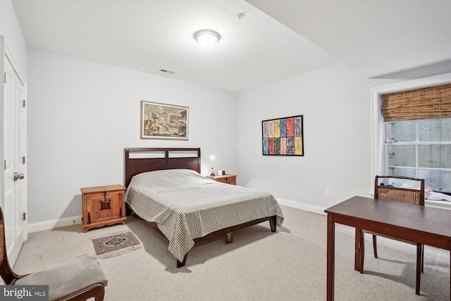 carpeted bedroom featuring baseboards