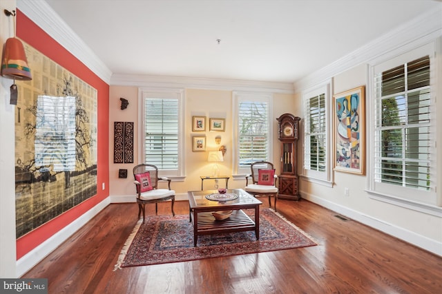 living area featuring crown molding, baseboards, and wood finished floors