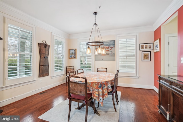 dining room featuring visible vents, crown molding, baseboards, and dark wood-style flooring