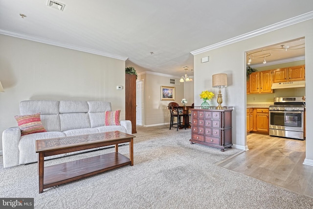 living room with light carpet, baseboards, visible vents, and ornamental molding