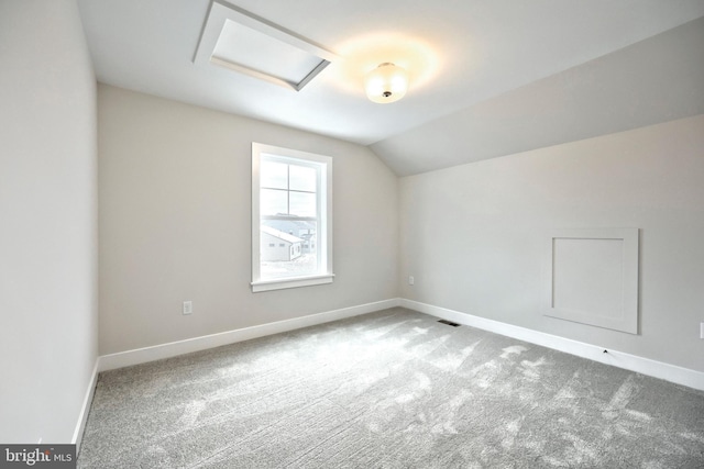 additional living space with vaulted ceiling and light colored carpet