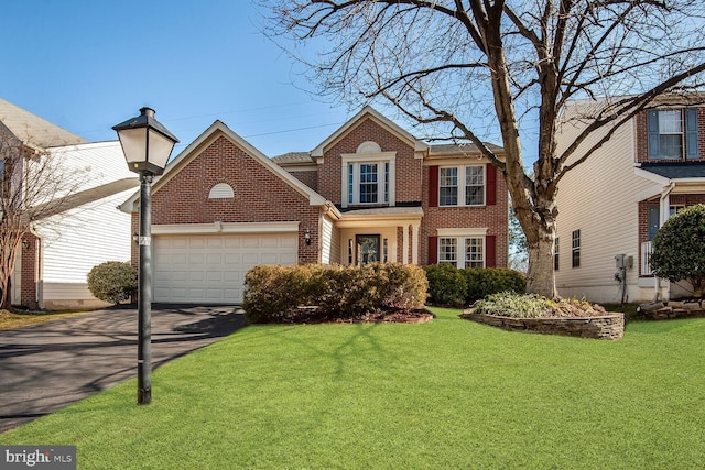 view of front of house with a front yard and a garage