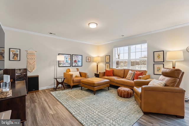 living room featuring ornamental molding and hardwood / wood-style flooring