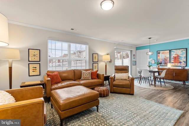 living room with hardwood / wood-style flooring and crown molding