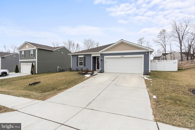 view of front of home with a front yard, driveway, and fence