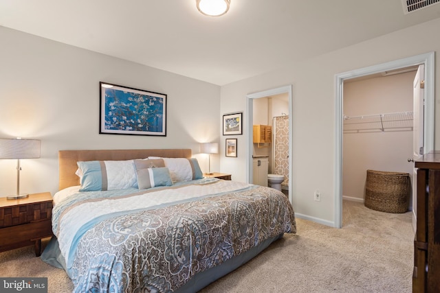 carpeted bedroom featuring a spacious closet, connected bathroom, and a closet