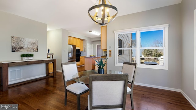 dining room with visible vents, baseboards, a notable chandelier, and dark wood-style floors