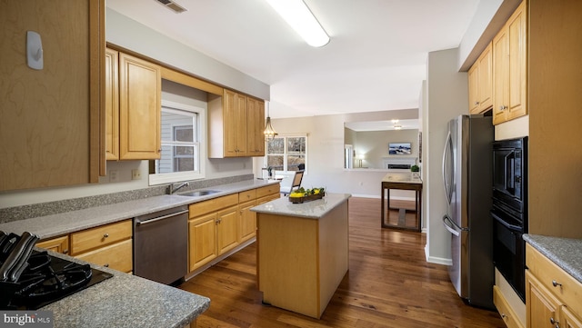 kitchen with black appliances, light brown cabinetry, a sink, a center island, and dark wood-style flooring