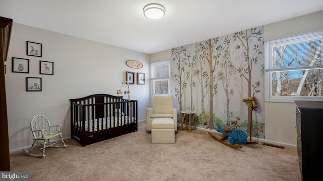 carpeted bedroom with multiple windows, baseboards, and a nursery area