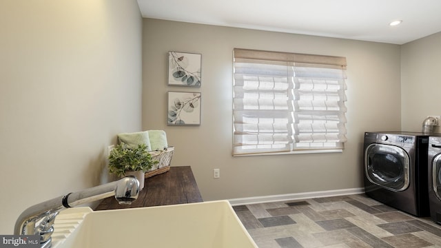 clothes washing area featuring washer and clothes dryer, laundry area, recessed lighting, and baseboards