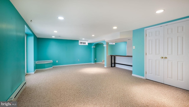 interior space featuring baseboards, recessed lighting, arched walkways, and a baseboard radiator