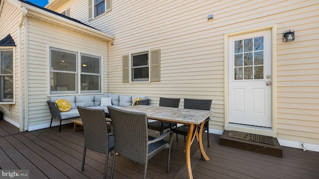 wooden terrace featuring outdoor dining area