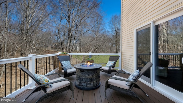 wooden terrace with a fire pit