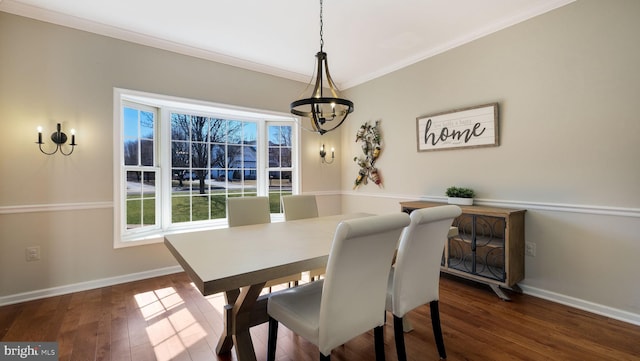 dining area with baseboards, dark wood-type flooring, and crown molding