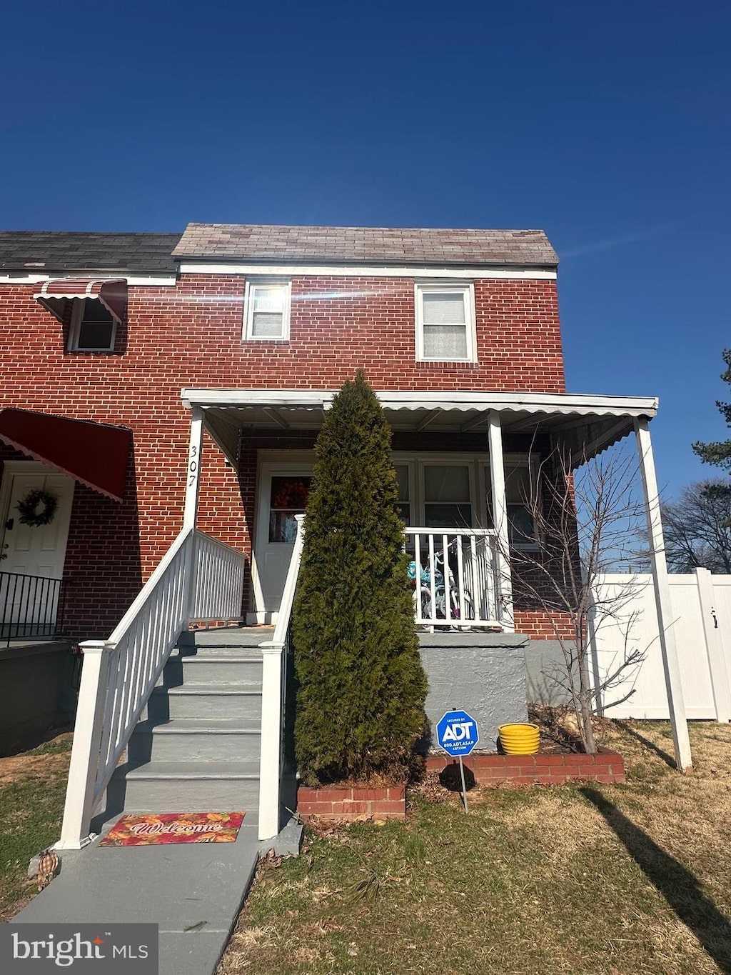 view of front of home with brick siding and covered porch