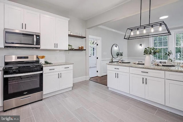 kitchen featuring stainless steel appliances, decorative light fixtures, light stone countertops, backsplash, and white cabinets