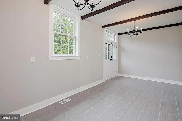 unfurnished dining area featuring a chandelier and beamed ceiling