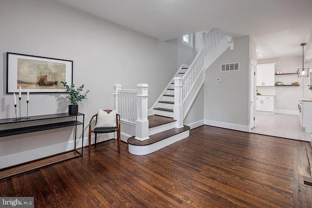 staircase with hardwood / wood-style floors