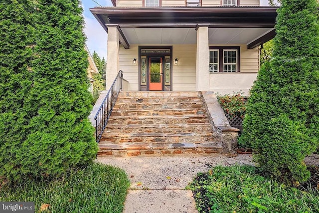 view of exterior entry with covered porch