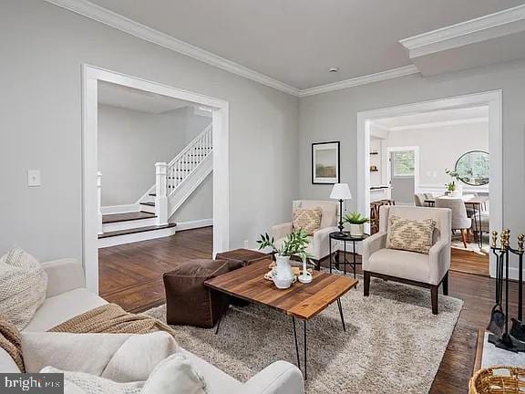 living room featuring ornamental molding and dark wood-type flooring