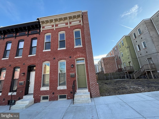 multi unit property featuring entry steps and brick siding