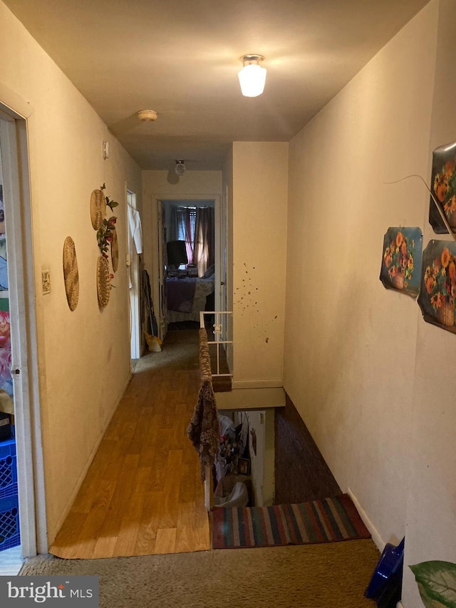 hallway with hardwood / wood-style floors