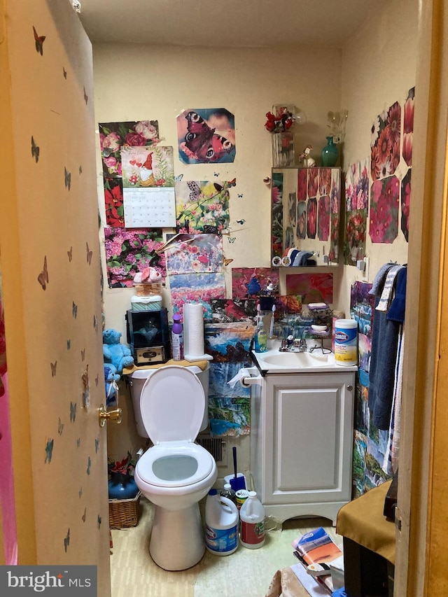 bathroom featuring toilet and vanity