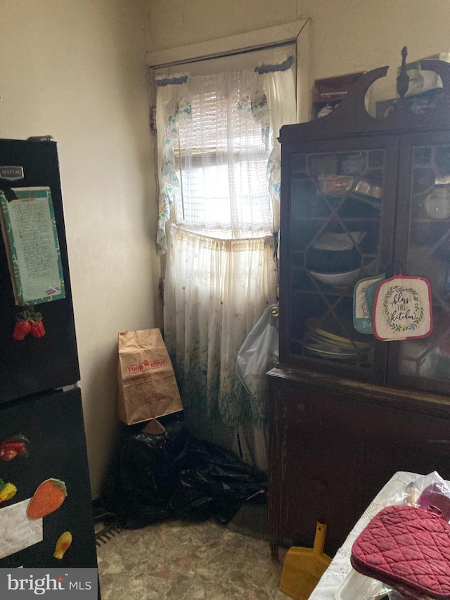 bedroom with black refrigerator